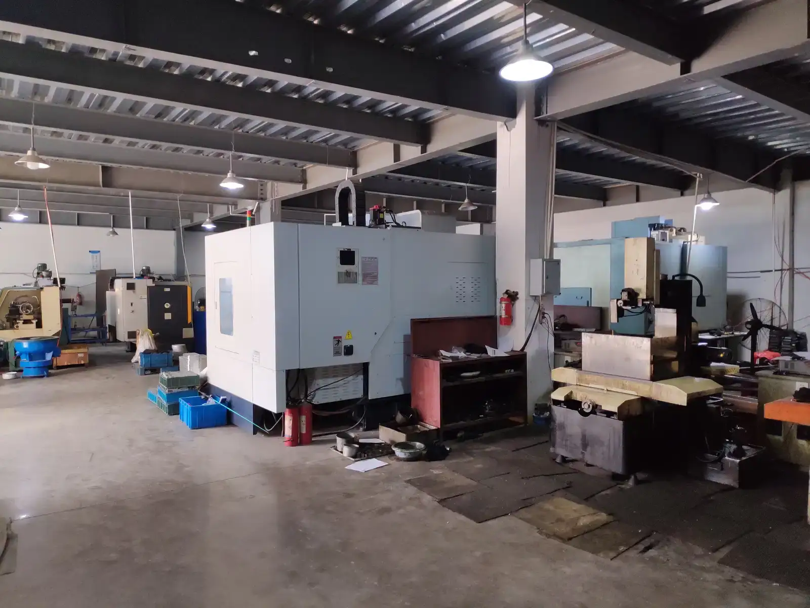 Industrial workshop interior with CNC machining equipment and tools