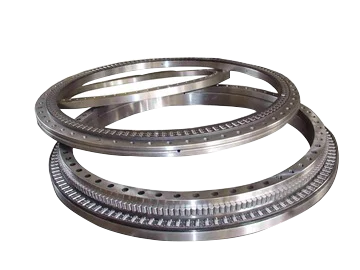 Metallic industrial slewing bearing rings stacked on an isolated background