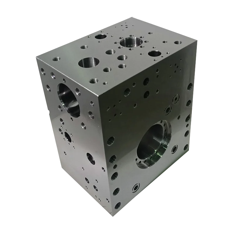 Precision machined metal hydraulic manifold block with drilled ports against a white background