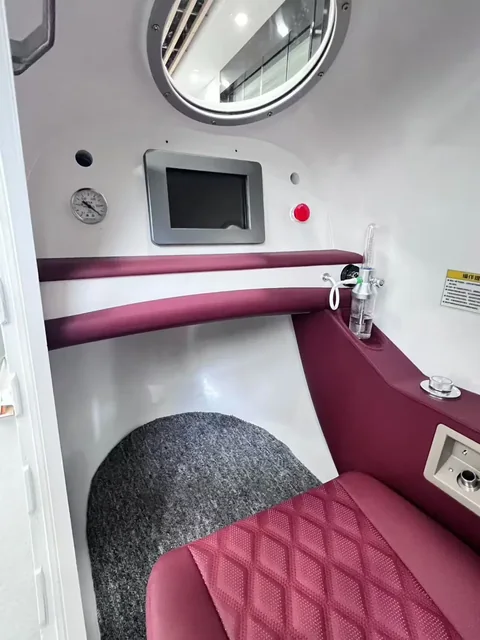 Upholstered zero-gravity seat and control screen inside the OHE20