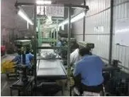 Die casting line in production — castings coming off the machine and moving straight to tr