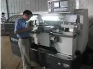 CNC lathe turning a cast part. The machining workshop has 20 sets of CNC lathes.