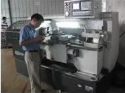 CNC lathe turning a cast part. The machining workshop has 20 sets of CNC lathes.