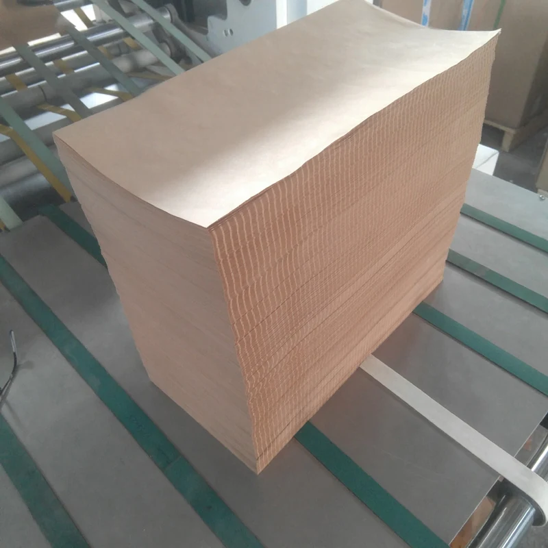 Perforated kraft paper being folded and stacked on the conveyor