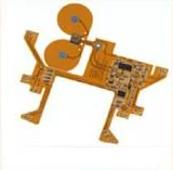 Assembled flexible circuit carrying a wound antenna coil and a populated component area