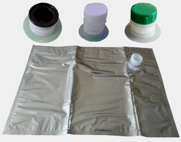 Silver foil liquid bag with spout and three plastic caps in black, white and green