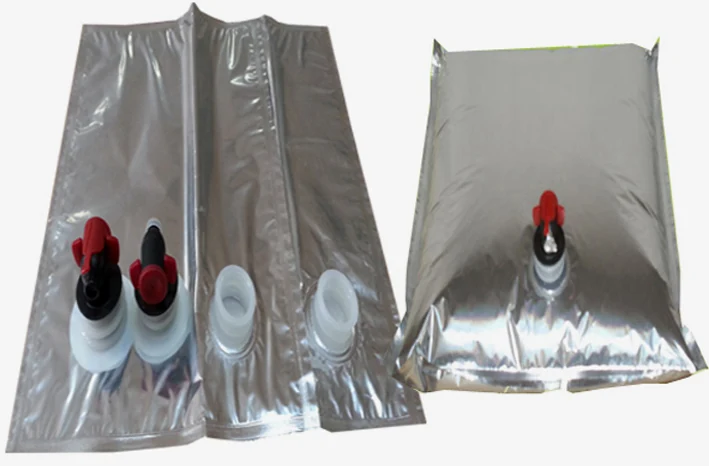 Two silver foil bag-in-box liners with red and white dispensing taps on white background