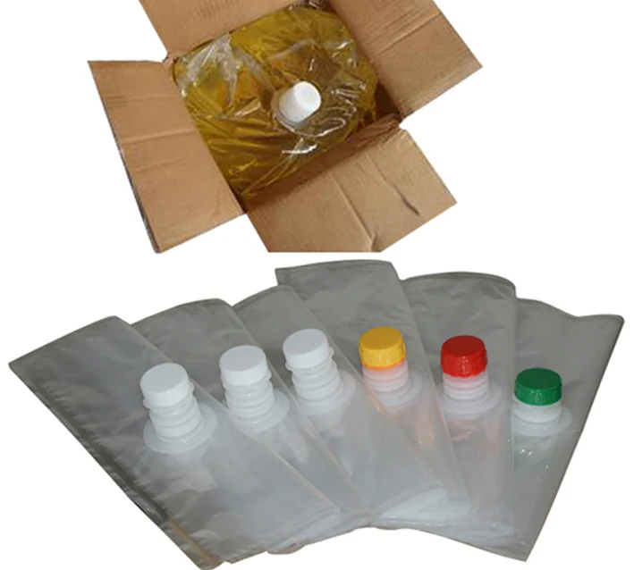Bag-in-box with yellow liquid in carton above six clear spout pouches with colored caps