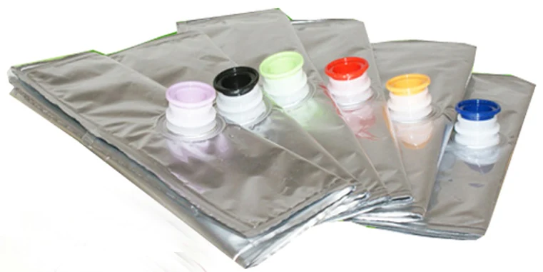 Silver foil spout pouches with pink black green red yellow blue caps fanned on white
