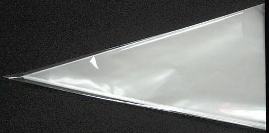 Clear triangular plastic bag lying on black textured surface