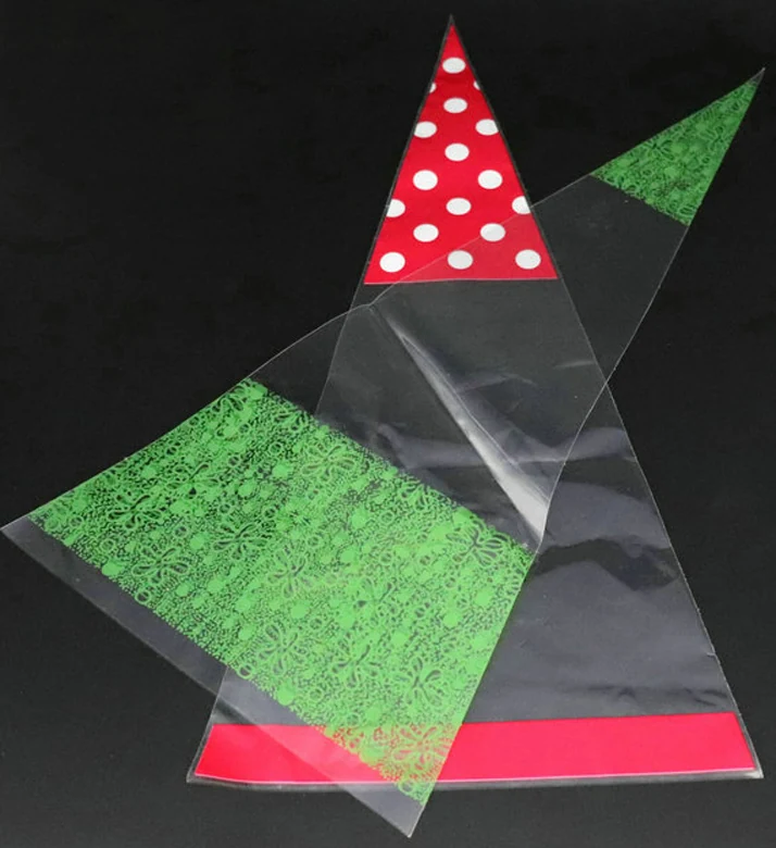 Clear cone-shaped plastic bags with red polka dot and green patterned tops on black background