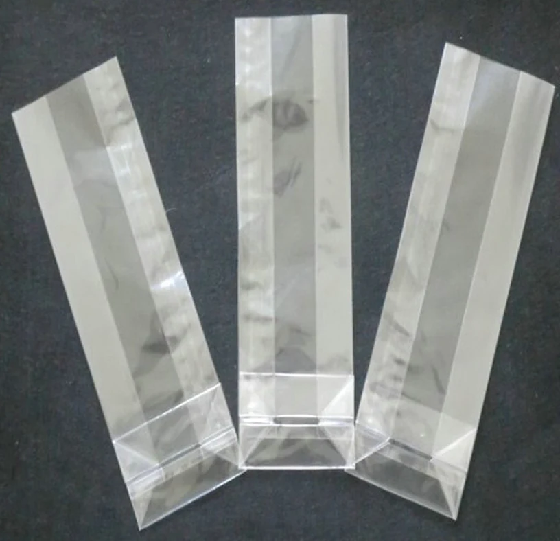 Three transparent plastic side-gusset bags on dark background