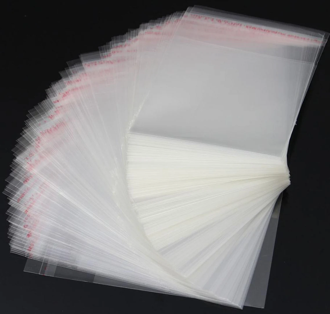 Stack of clear resealable plastic bags fanned out on black background