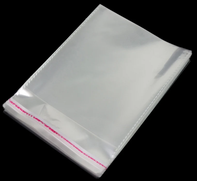 Stack of clear self-seal plastic bags with pink strip on black background
