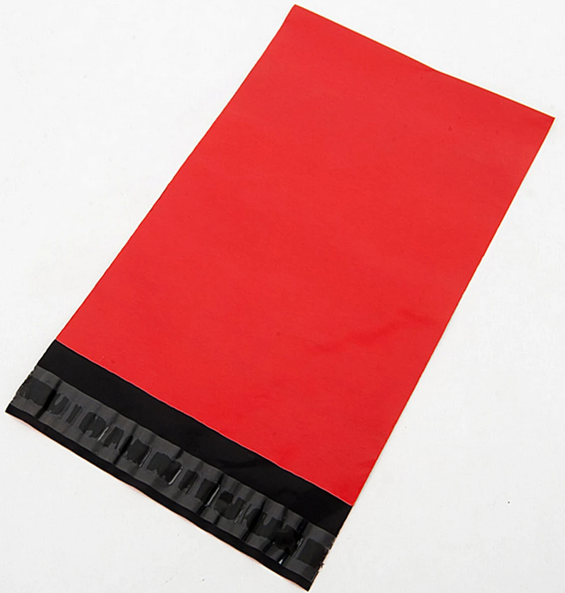 Red poly shipping mailer bag with black adhesive seal on white background