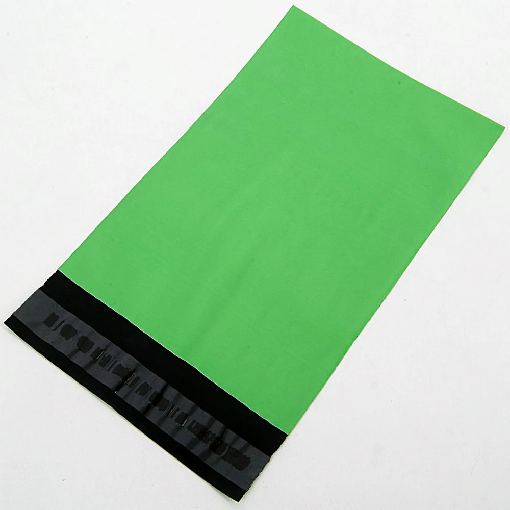 Green poly mailer shipping bag with black adhesive seal on white background