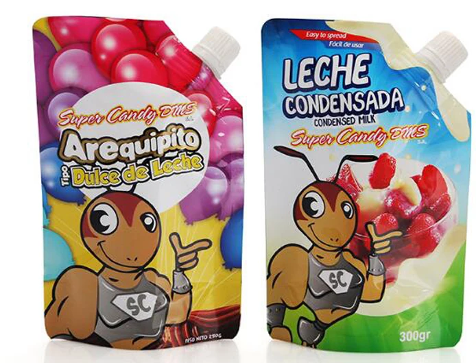 Two colorful spouted pouches of dulce de leche and condensed milk with cartoon ant