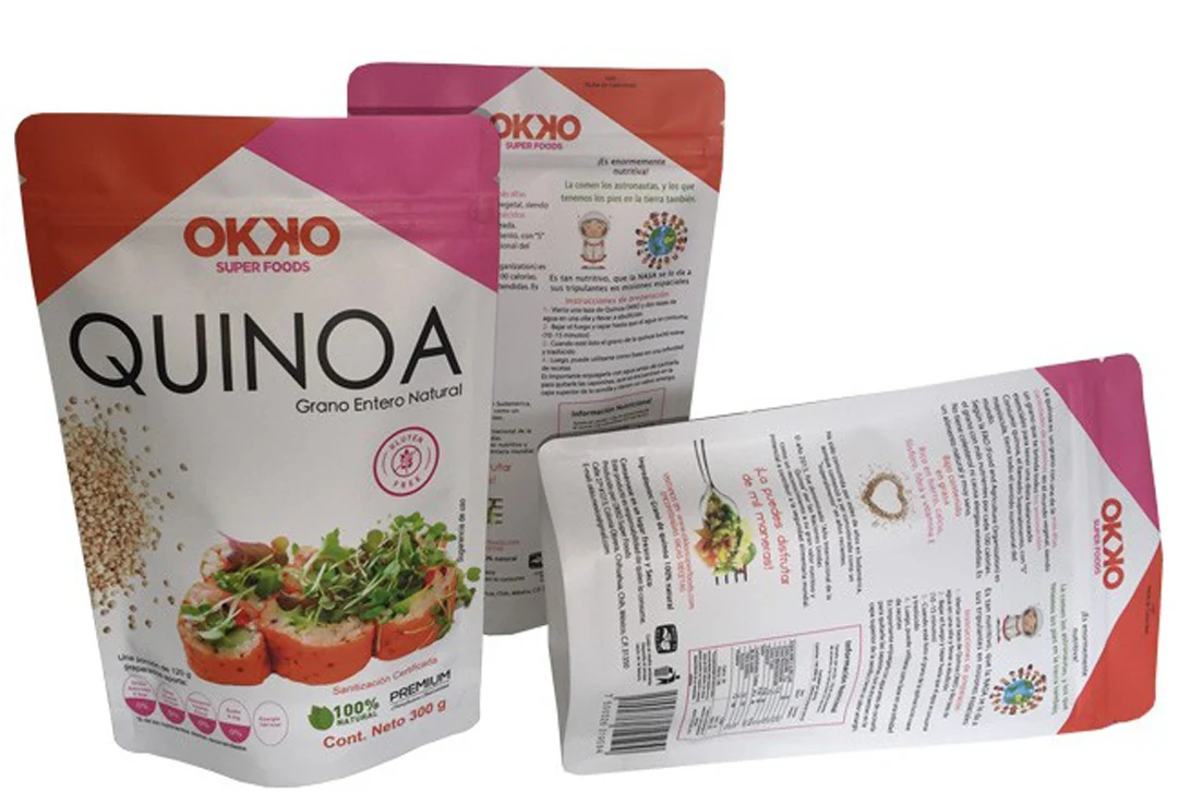 Three OKKO Quinoa stand-up pouches showing front and back labels on white background