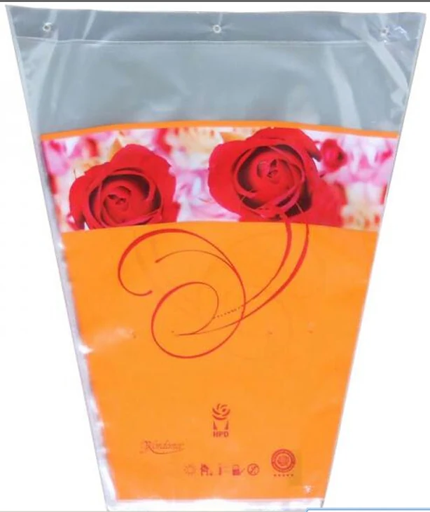 Clear plastic flower sleeve with orange base printed with red roses