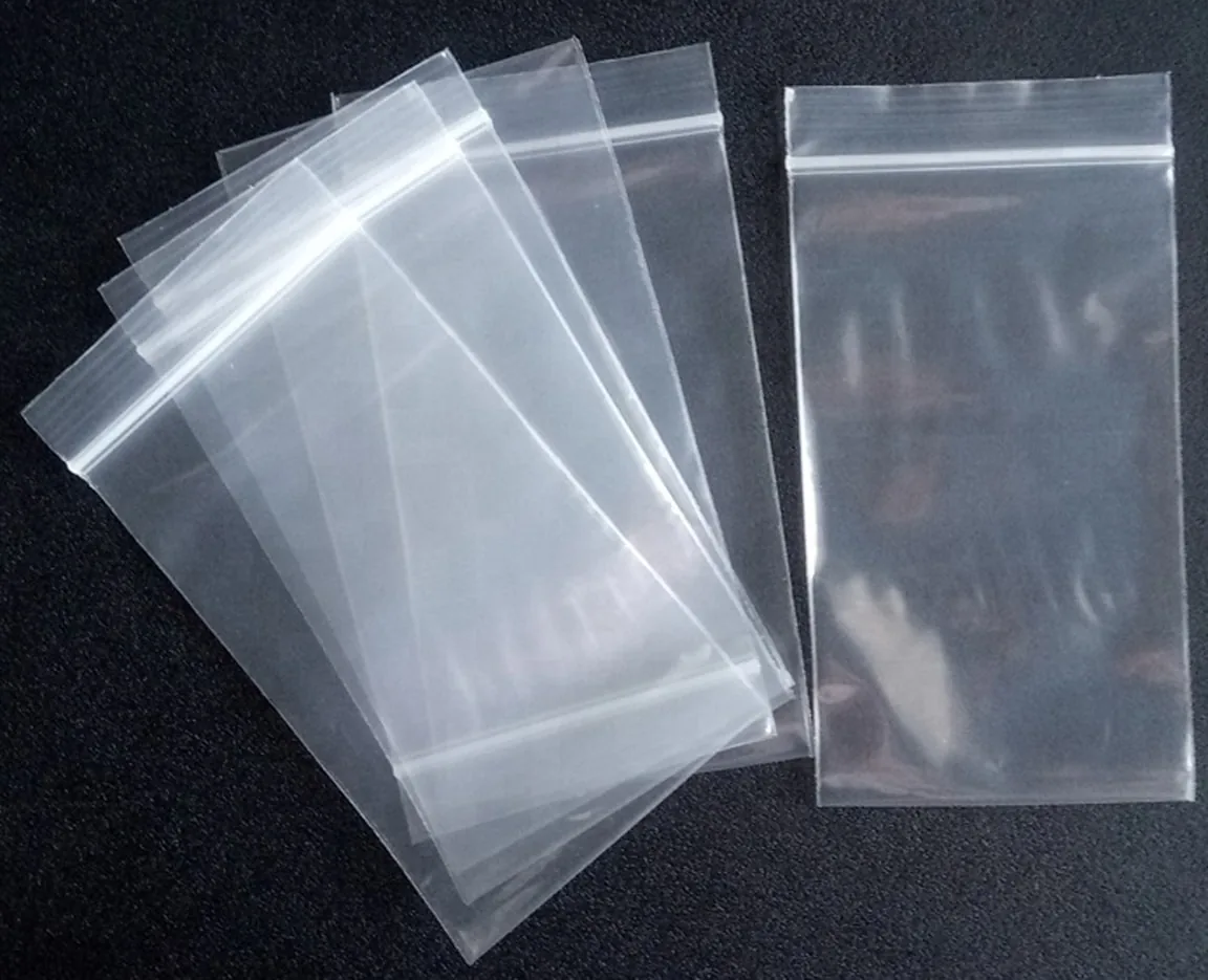 Clear resealable plastic zip bags arranged on black background