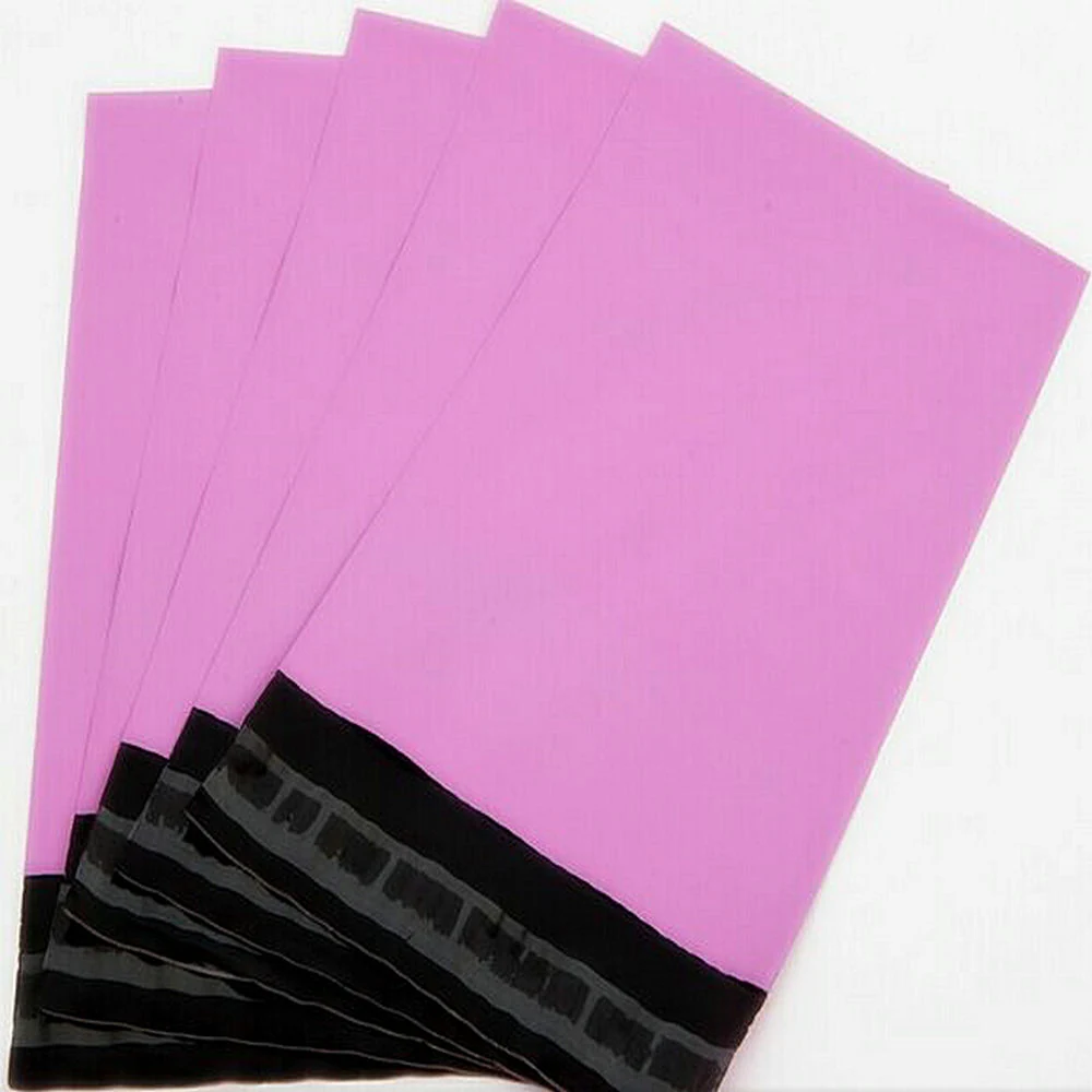 Five pink poly mailer shipping bags with black adhesive strips fanned on white background