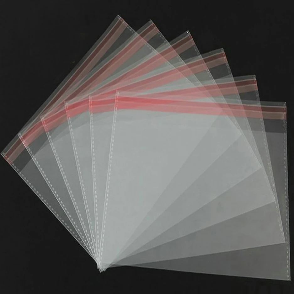 Clear self-seal plastic bags fanned out on black background