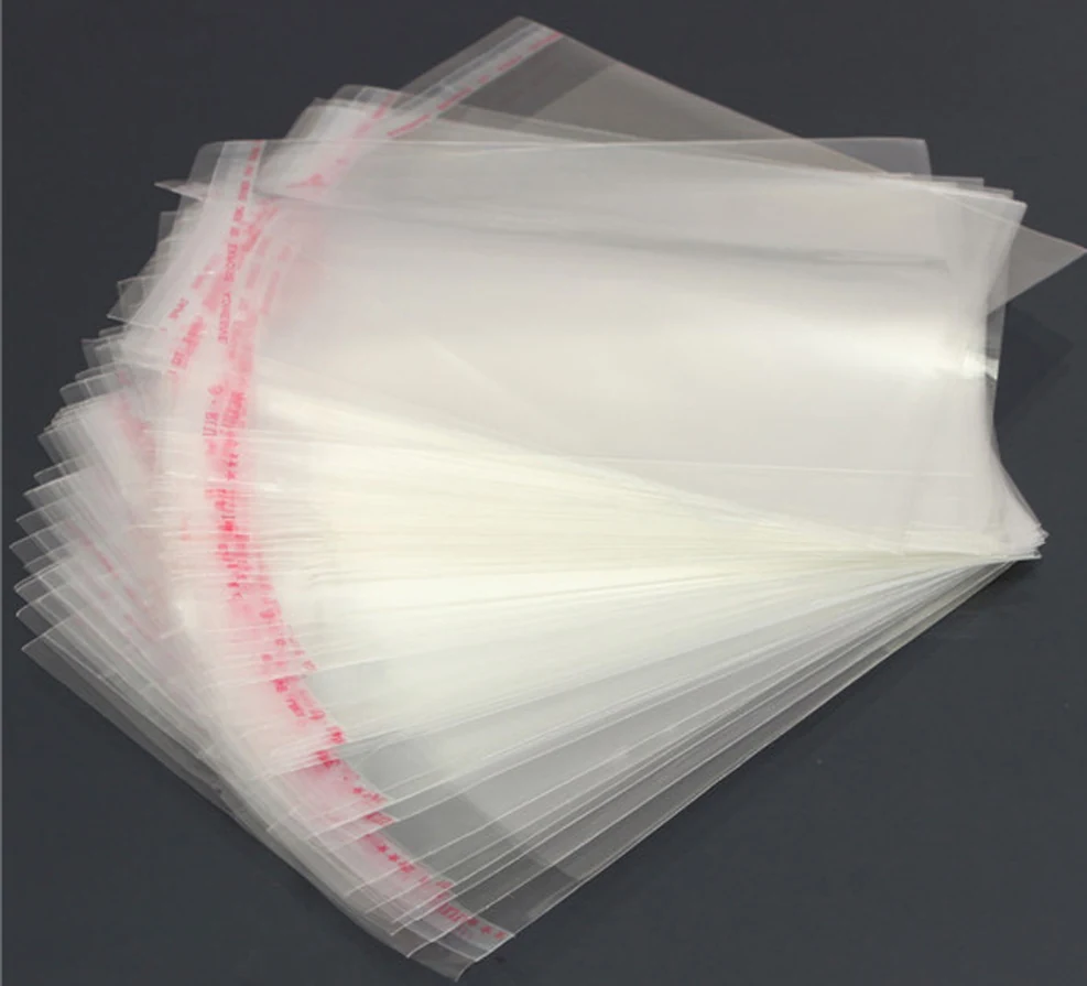 Stack of clear self-seal plastic bags fanned out on dark surface