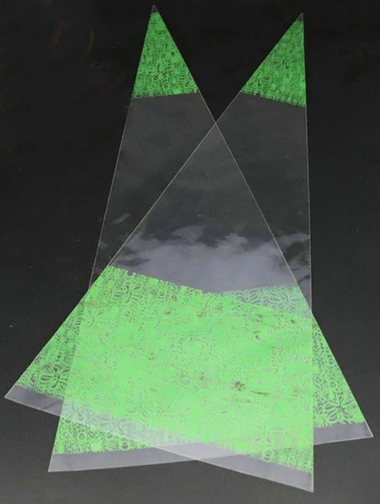 Three clear cone bags with green pattern on black background