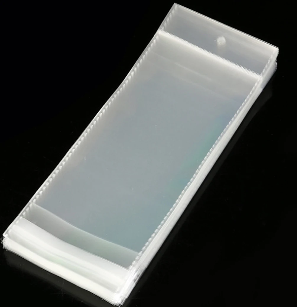 Stack of clear plastic packaging bags on black background