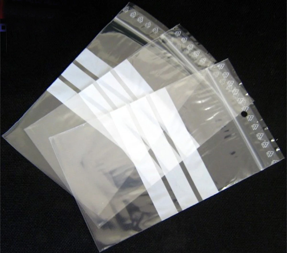 Clear resealable plastic bags with white write-on stripes on black background