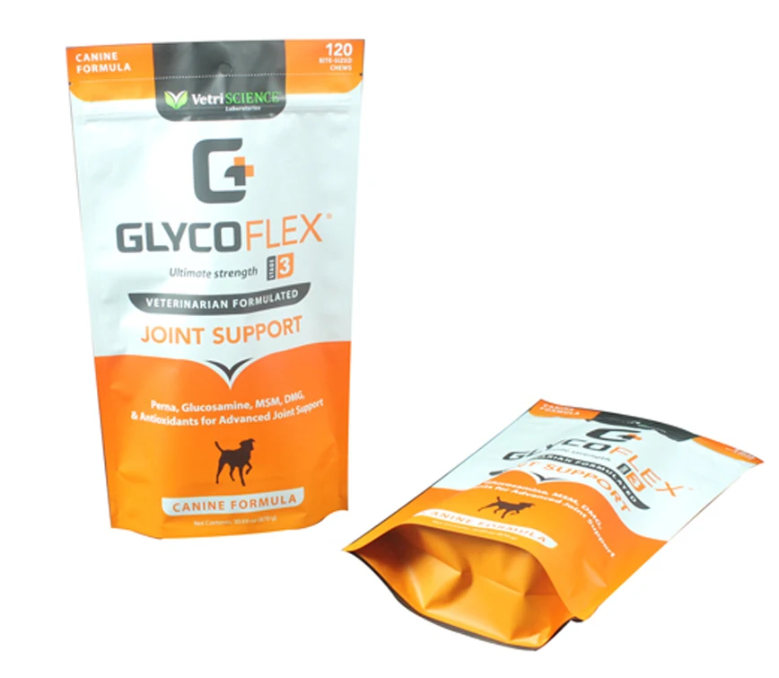 Two orange and white stand-up pouches for canine joint support on white background