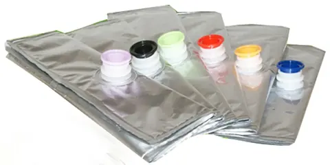 Silver foil spout pouches with pink black green red yellow blue caps fanned on white