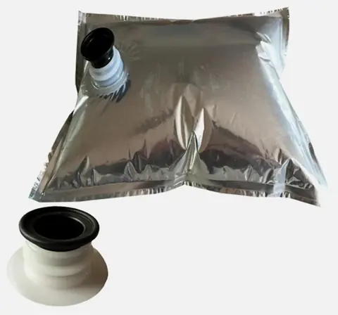 Silver foil bag-in-box liner with black dispensing spout and spout detail on white background