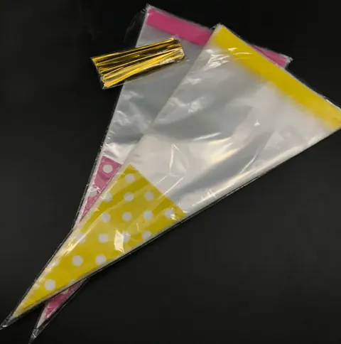 Two clear cone cello bags with yellow and pink polka dots and gold twist ties