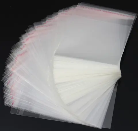 Stack of clear resealable plastic bags fanned out on black background