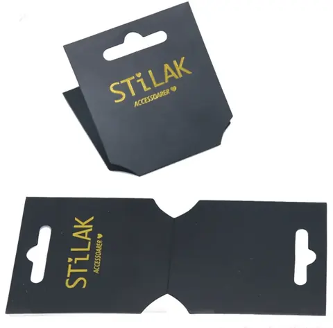 Two black cardboard hang tags with gold lettering shown folded and flat on white background
