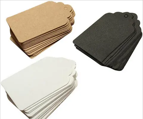 Three stacks of blank brown, black and white paper tags on white background