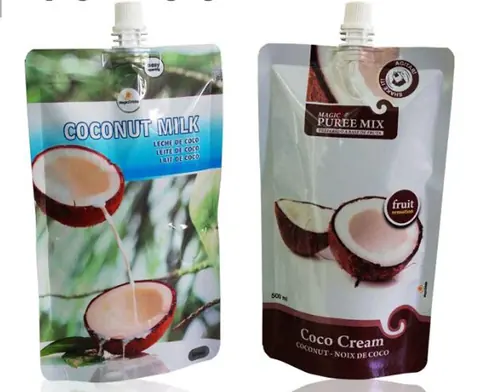Two spouted stand-up pouches labeled coconut milk and coco cream with halved coconuts