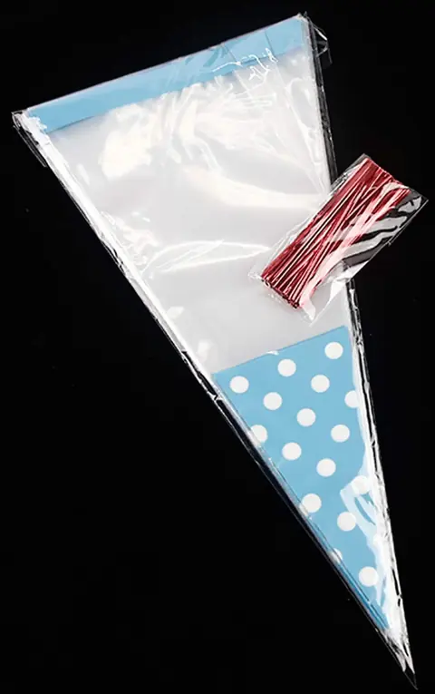 Clear plastic cone bag with blue polka dot base and red twist ties on black background