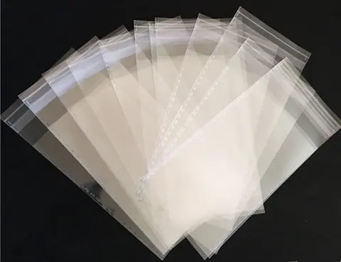 Transparent plastic bags fanned out on black background