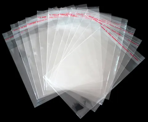 Fanned stack of clear resealable plastic bags on black background