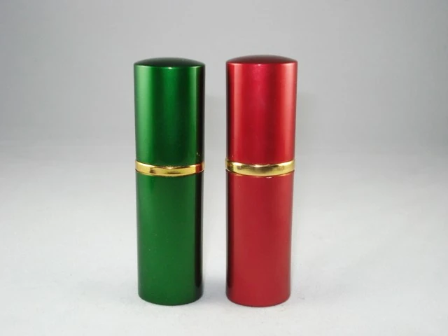 Two cylindrical metal containers, one green and one red, standing upright on a white background.