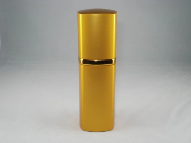 Gold metallic cylindrical pump bottle standing upright against a plain light gray background