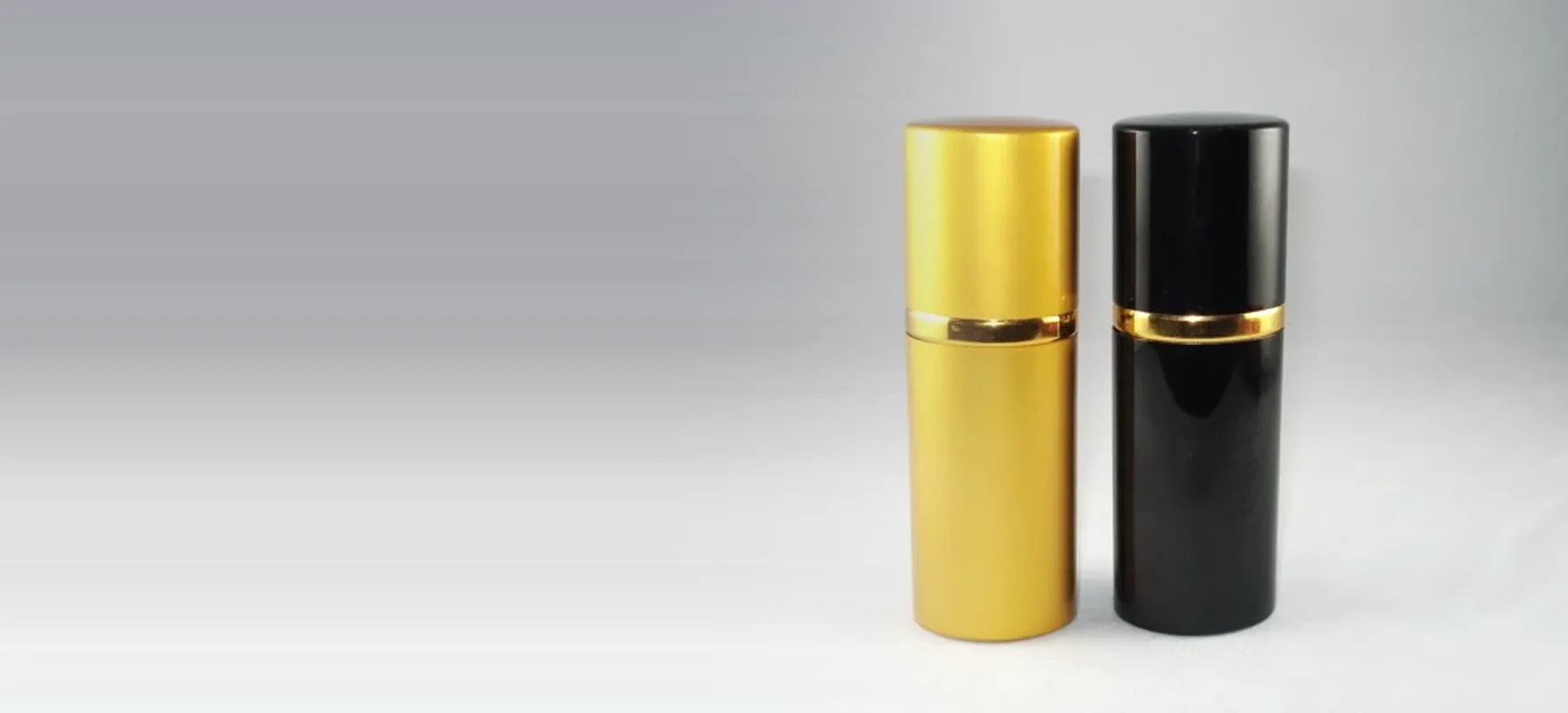 Gold and black anodized aluminium perfume atomizers from the C series