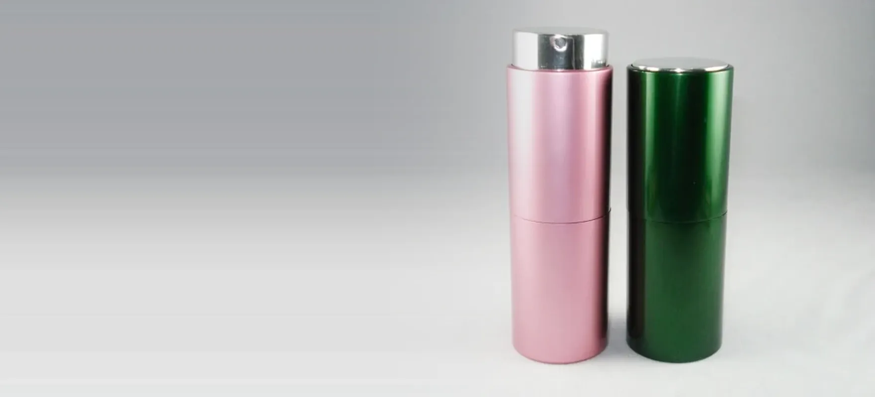 Pink and green aluminium perfume atomizers with pump and cap fitted