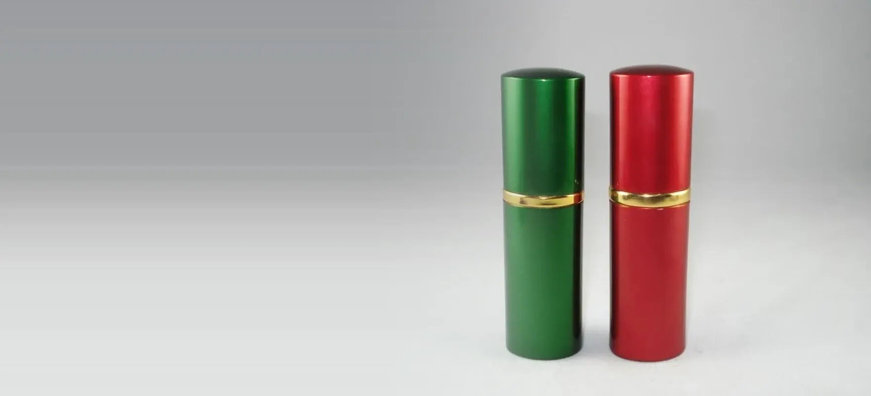 Green and red anodized aluminium perfume atomizers with gold centre bands