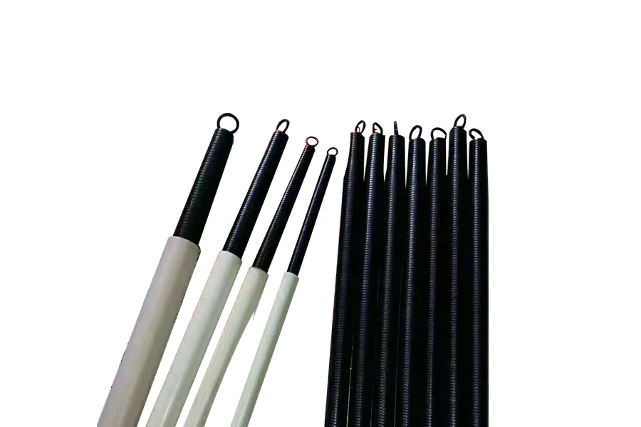 Bending spring being fed into a PVC conduit during installation