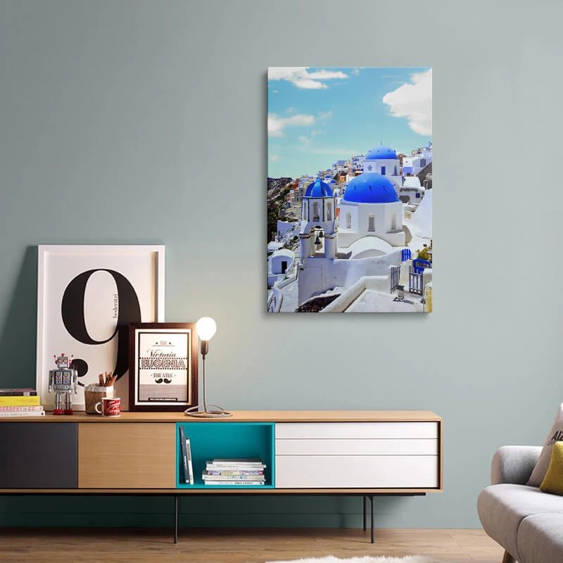 Blue Dome Church Santorini canvas hung above a sideboard in a living room