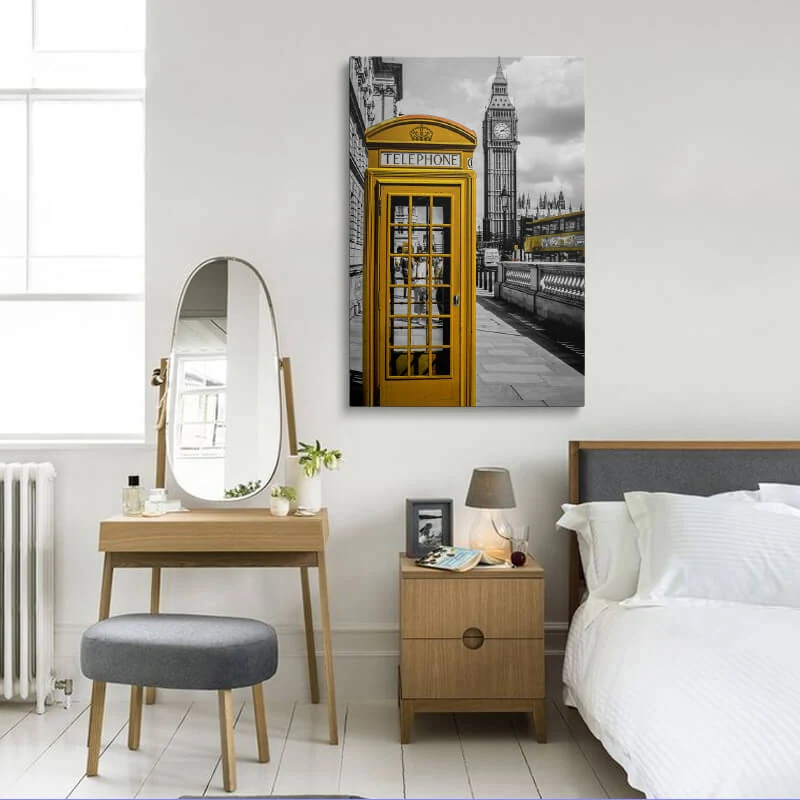 Orange London Telephone Box canvas hung in a bedroom above a bedside table