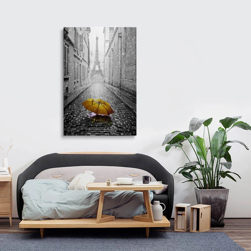 Orange Umbrella Eiffel Tower canvas hung above a sofa in a lounge